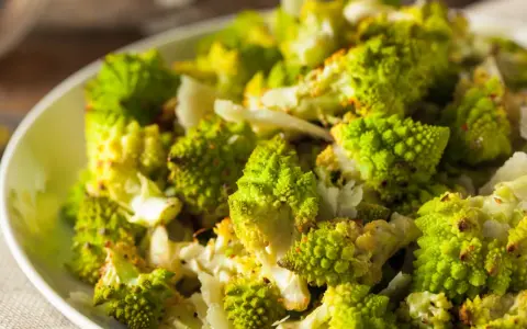 Zielony kalafior romanesco na talerzu. Czy kalafior jest lekkostrawny? Ten wygląda apetycznie i zdrowo.